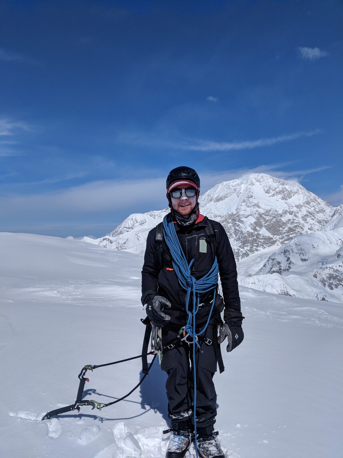 Chance on the summit of Begguya with Denali in the background
